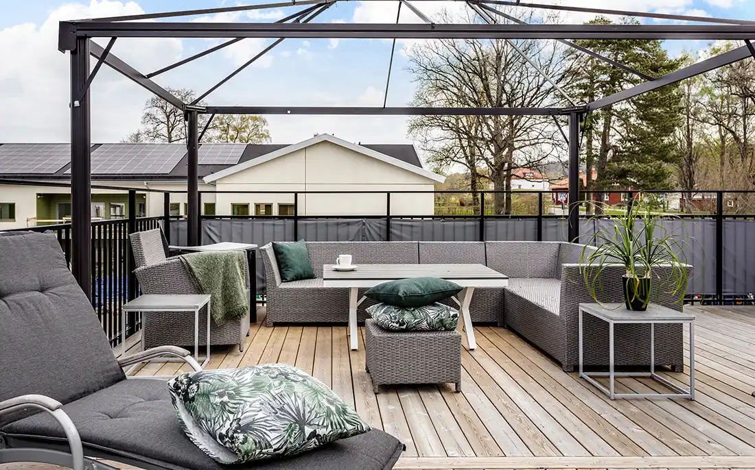 Träbeklädd terrass med loungemöbler